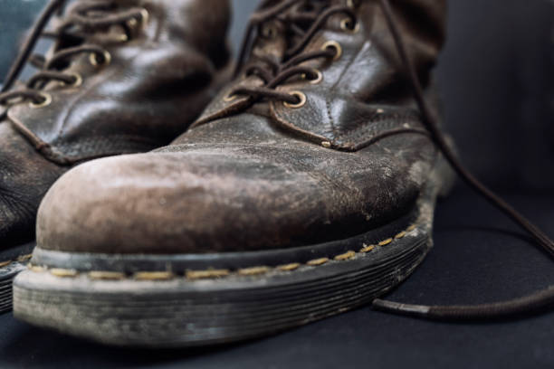 istock Old dirty brown shoes, close up 1216526318