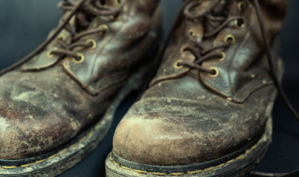 istock Old dirty brown shoes, close up 1216526348