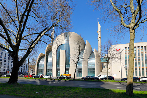 Cologne, Germany - April 01, 2020. The Central Mosque is designed by German architect Paul Böhm in non-Ottoman style - with concrete and glass. The building is one of the biggest mosque in Europe. Fast road (Innere Kanalstraße) in front.