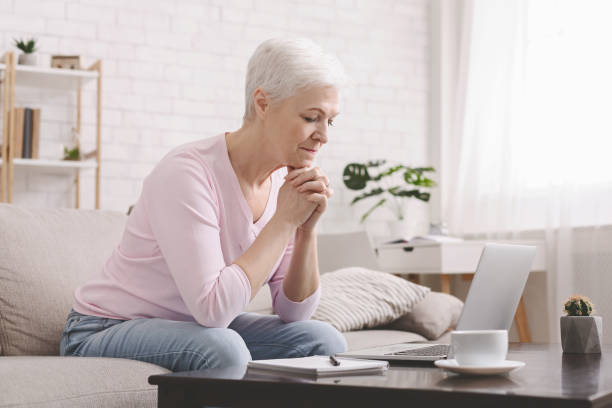 istock Sad senior lady looking at laptop with perplexity 1216528608