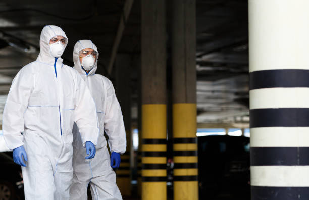 Men in virus protective suits patrol the city while quarantine