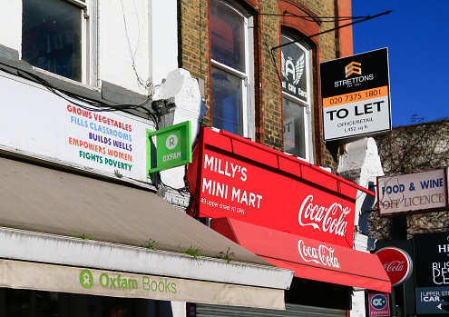 Milly's Mini Mart in Islington, London next to Oxfam Bookstore, with to let signs in the background