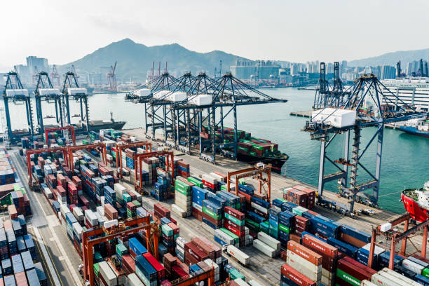 istock Container cargo freight ship with working crane bridge discharge at container terminal, Drone view container ship at deep sea port. 1216530990