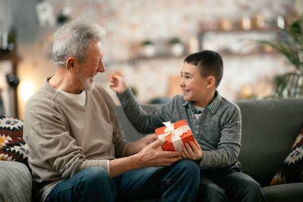 istock Grandpa giving his grandson present. 1216532192