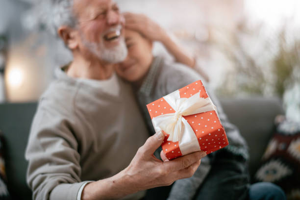 istock Grandpa giving his grandson present. 1216532195