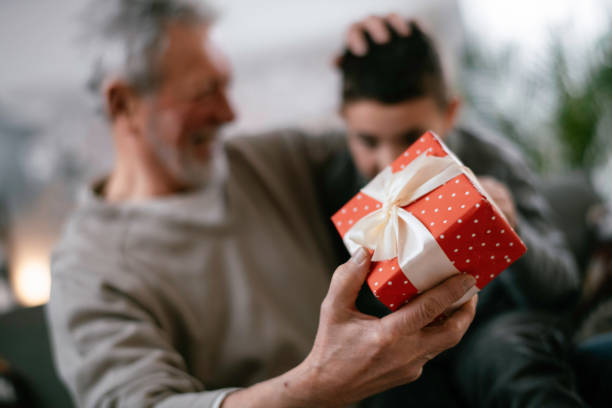 istock Grandpa giving his grandson present. 1216532226