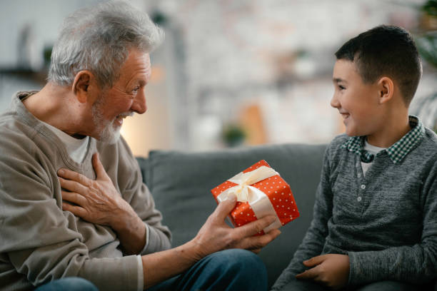 istock Grandpa giving his grandson present. 1216532230