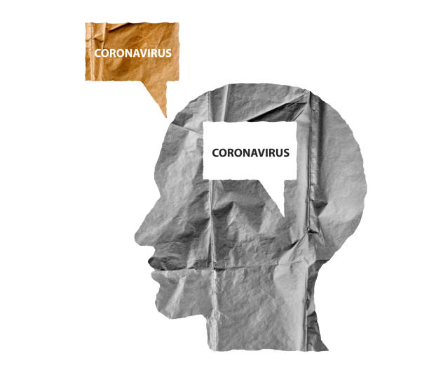 istock Crumpled paper shaped as a human head and talk balloon on white. Paper human head with Coronavirus text. COVID-19 crisis concept. 1216532507