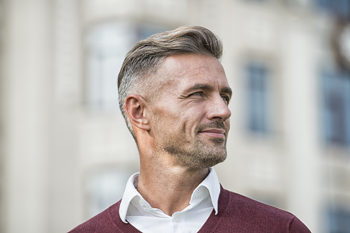 Facial care and ageing. Attractive mature man. Mature guy with grey hair and bristle outdoors. Men get more attractive with age. Hairdresser salon. Stylish hairstyle. Male face. Businessman concept.