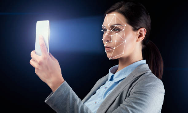 istock Young businesswoman using facial recognition system for data protection on black background 1216534669