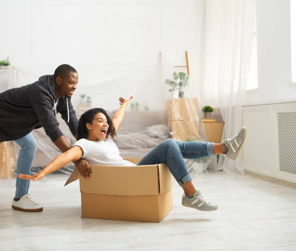 istock African american guy pushes box with a laughing girl 1216535366