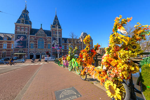 Decorated bicycles on the Museumbridge in front of the Rijksmuseum in Amsterdam, The Netherlands during a beautiful springtime morning.