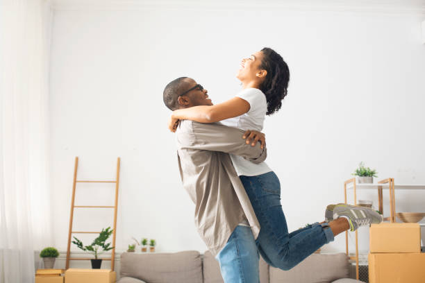 istock Couple have fun indoors, hugging and whirling 1216535744