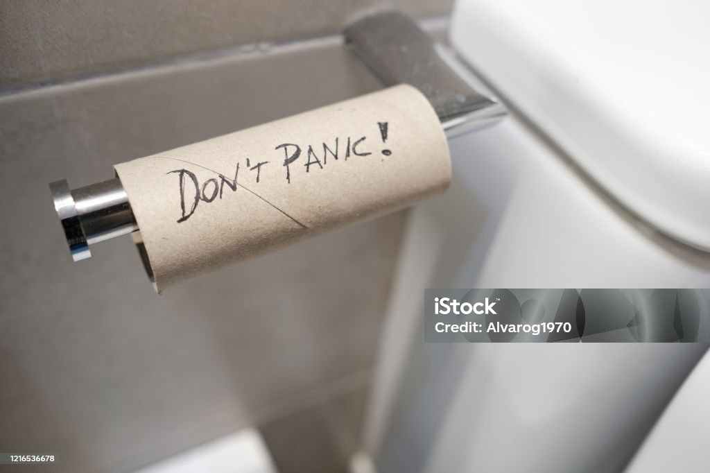 empty toilet roll with Don't panic message written on it - Corona virus concept Humor Stock Photo