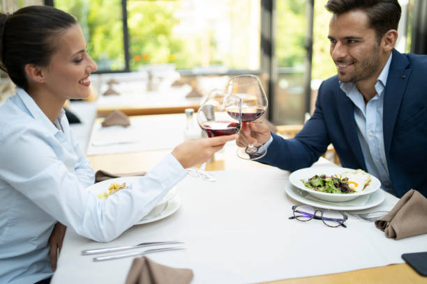 istock Romantic couple dining in restaurant, cheering 1216538685