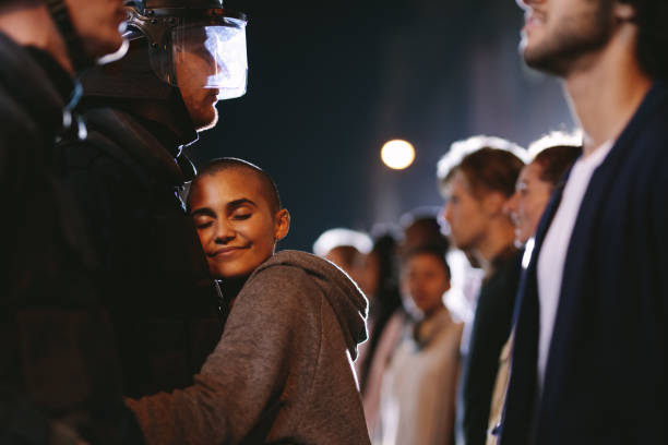 istock Woman activist hugging a policeman 1216538904
