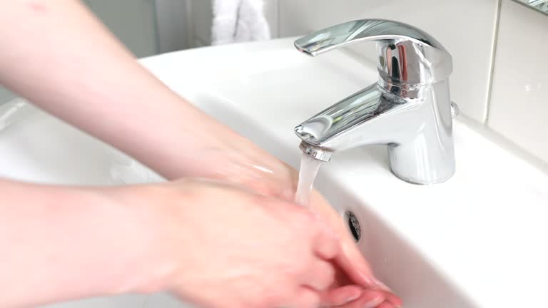 Woman intensively washing her hands with soap