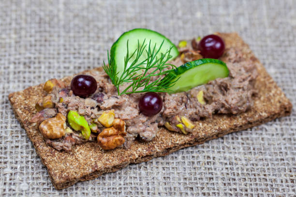 istock Dietary nutrition. Quail paste with peanuts on crisp bread. Fresh goose paste, 1216541783