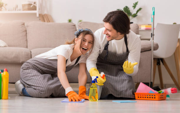istock Spring-Clean. Young Couple Having Fun While Cleaning House, Washing Floor Together 1216542855