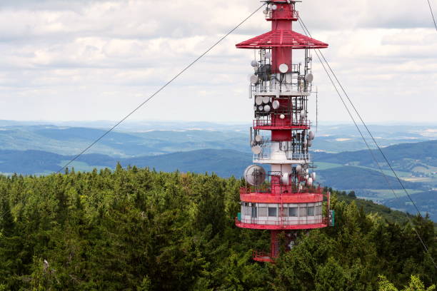istock Telecommunication tower with transmitters and aerials, wireless communication and internet traffic increase concept 1216543747