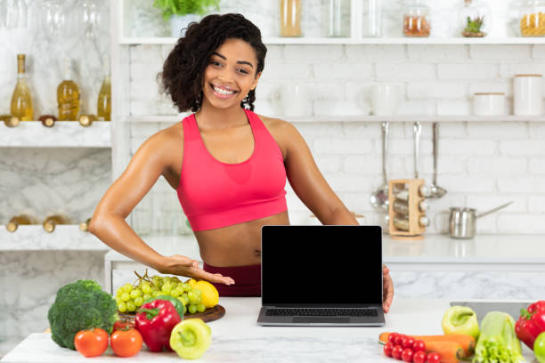 istock Black girl using laptop to shopping online 1216544147