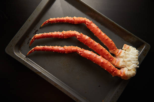 istock Image of fresh crab phalanges on oven-tray over dark background with copyspace 1216544294