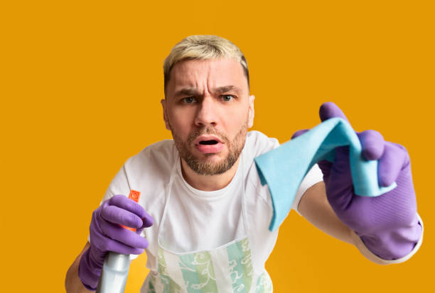 istock Housekeeping concept. Funny boy wiping screen sponge 1216544330