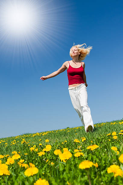 istock young woman in red outfit having fun on meadow 121654452