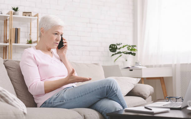 istock Angry senior woman talking on phone with service manager 1216546511