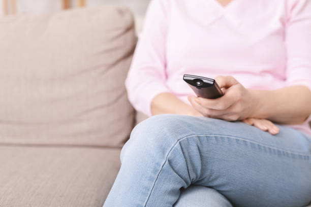 istock Senior lady watching tv at home, free space 1216546698