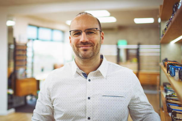 Young optician presents his retail store