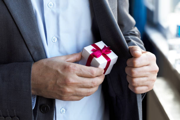 istock Businessman giving Gift Box 1216547950