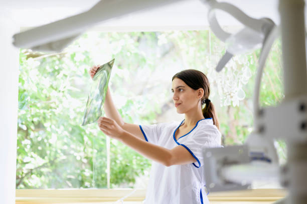 istock Female dentist looking at x-ray with concerned expression 1216548658