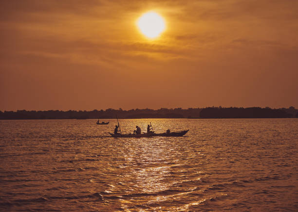 istock Silhouette People On Sea Against Sky During Sunset 1216549240