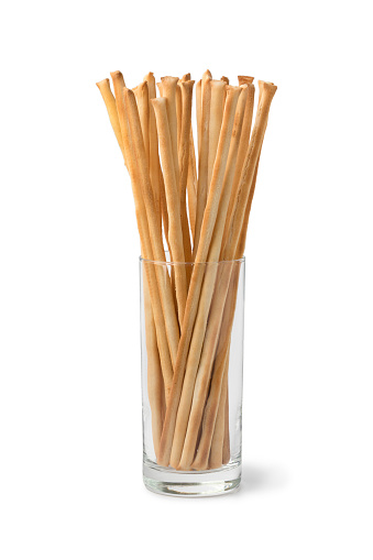 Italian breadsticks in a glass isolated on white background
