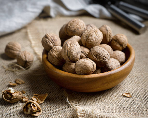 istock Nuts in a wooden plate 1216550985