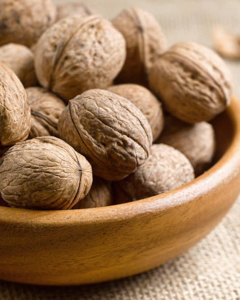 istock Vertical closeup nuts in a wooden plate 1216551387