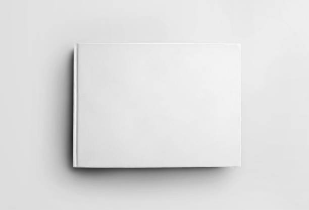 istock Mockup blank white closed book isolated on background, front view. Hardcover landscape orientation object template for design presentation. 1216552860