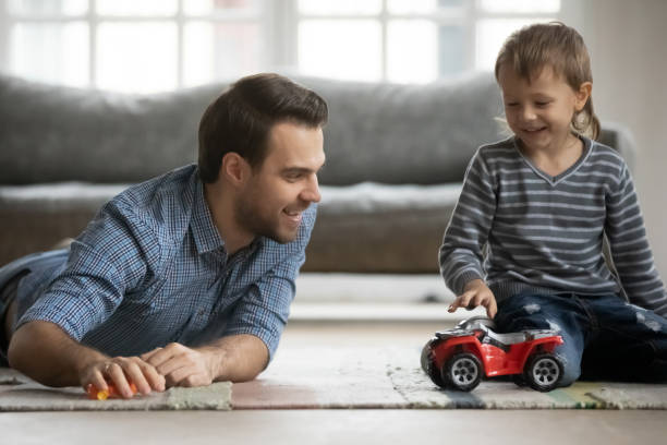 istock Joyful young father playing car toys with son. 1216554309
