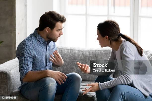 Stressed Young Married Family Couple Arguing Blaming Each Other Stock Photo - Download Image Now