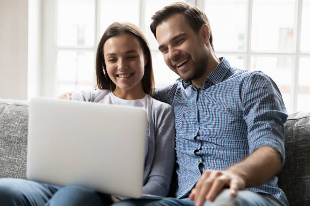 istock Happy married couple watching funny video on computer. 1216554360