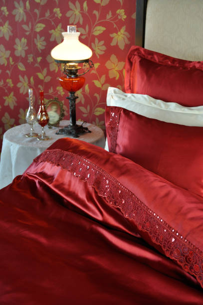 Red & white sheet set Life-style shooting of a red & white sheet set with guipure red cushion covers stock pictures, royalty-free photos & images