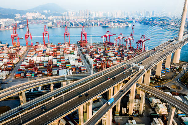 istock Highway Bridge in Hong Kong and Container Cargo freight ship 1216554978
