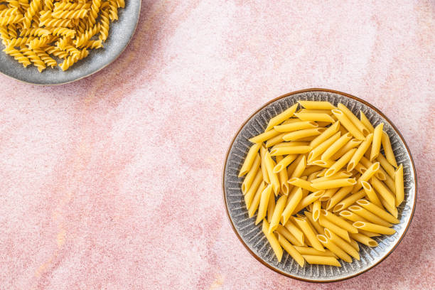 istock Different types of uncooked pasta in plate 1216555653