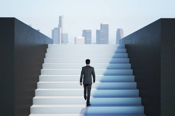 istock Businessman climbing on ladder 1216559138