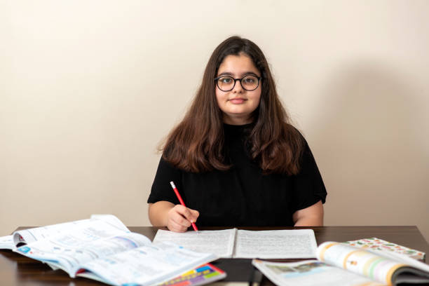 istock 13 years old girl doing homework 1216559240