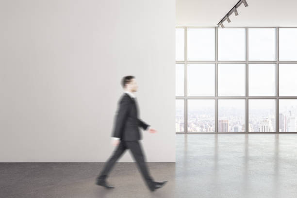 istock Businessman walking in modern interior 1216559358