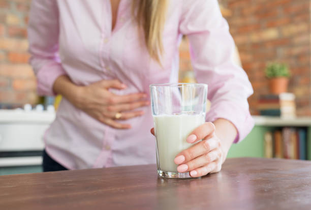 Woman feeling sick by drinking milk Woman having pain in stomach, feeling sick by drinking milk lactose fermentation stock pictures, royalty-free photos & images