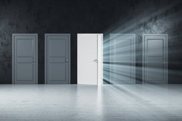 istock Creative white doors to success in gray concrete room 1216560873