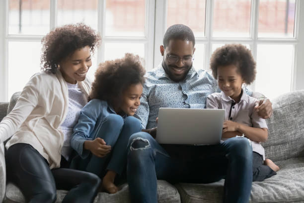 istock African full family using laptop having fun online at home 1216562015